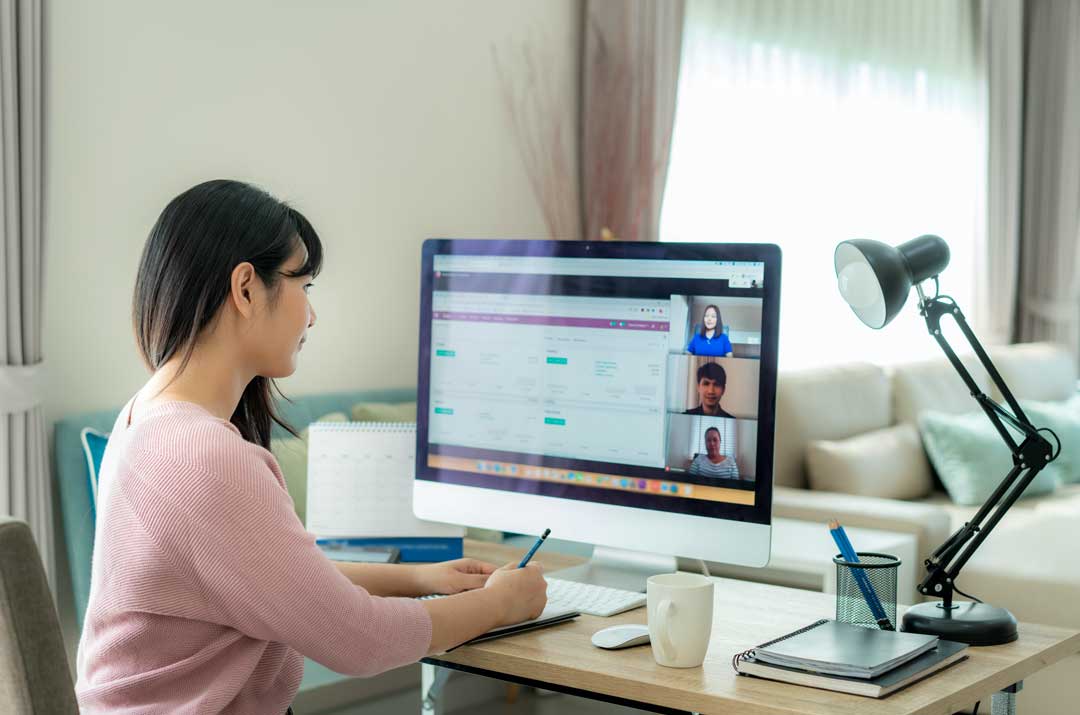 Woman at a desk exploring parts of a CV to build a CV.