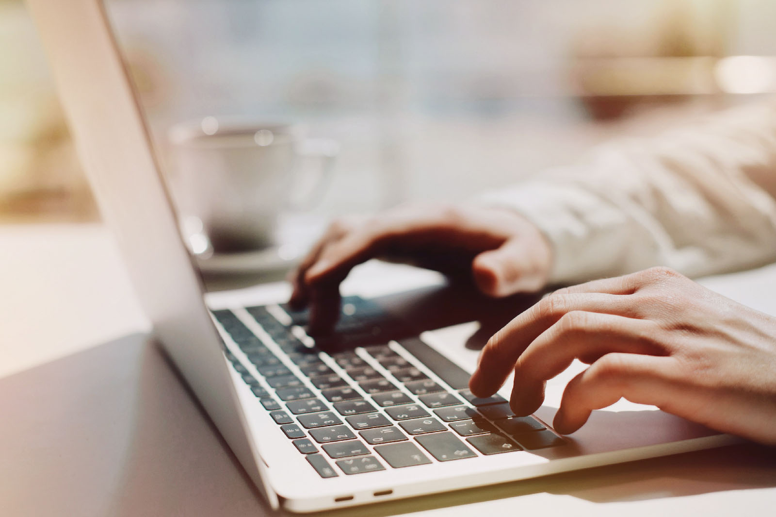 Fingers on laptop keyboard search for What is a CV?